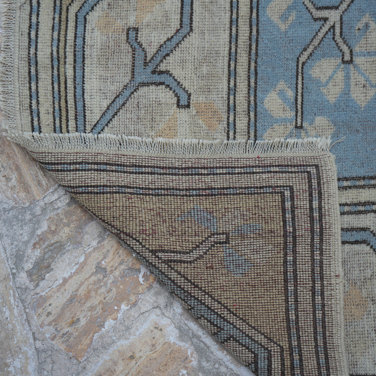1970s pale blue vintage Turkish wool rug with geometric design, hand-knotted weave and low pile.