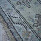 Beige 6' x 9' vintage Turkish wool rug in wool, shown on the floor.