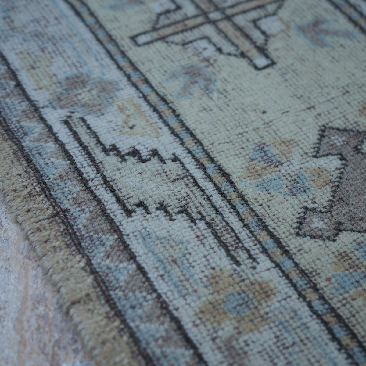 Beige 6' x 9' vintage Turkish wool rug in wool, shown on the floor.