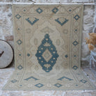 Beige 7' x 10' vintage wool rug with neutral and geometric design, handmade in Turkey – Gertie.