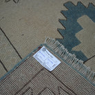 Beige 7' x 10' vintage Turkish wool rug from the 1970s with neutral and geometric design.