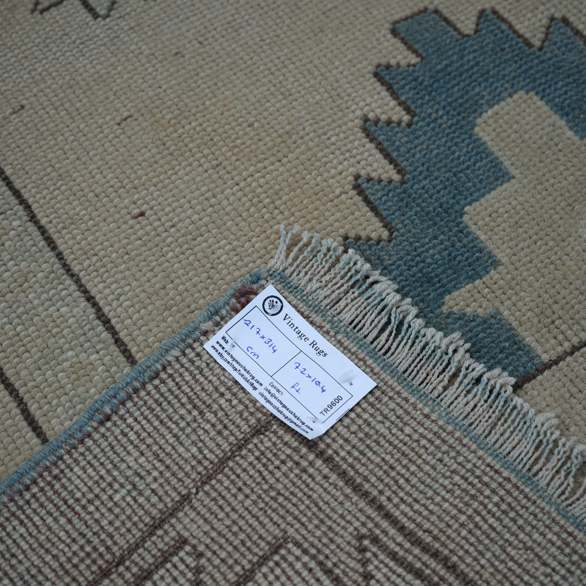 Beige 7' x 10' vintage Turkish wool rug from the 1970s with neutral and geometric design.