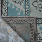 1970s pale blue vintage Turkish wool rug with geometric design, hand-knotted weave and low pile.