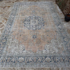 Close-up of the orange vintage Turkish wool rug showing medallion details, hand-knotted weave, wool and cotton and low pile.