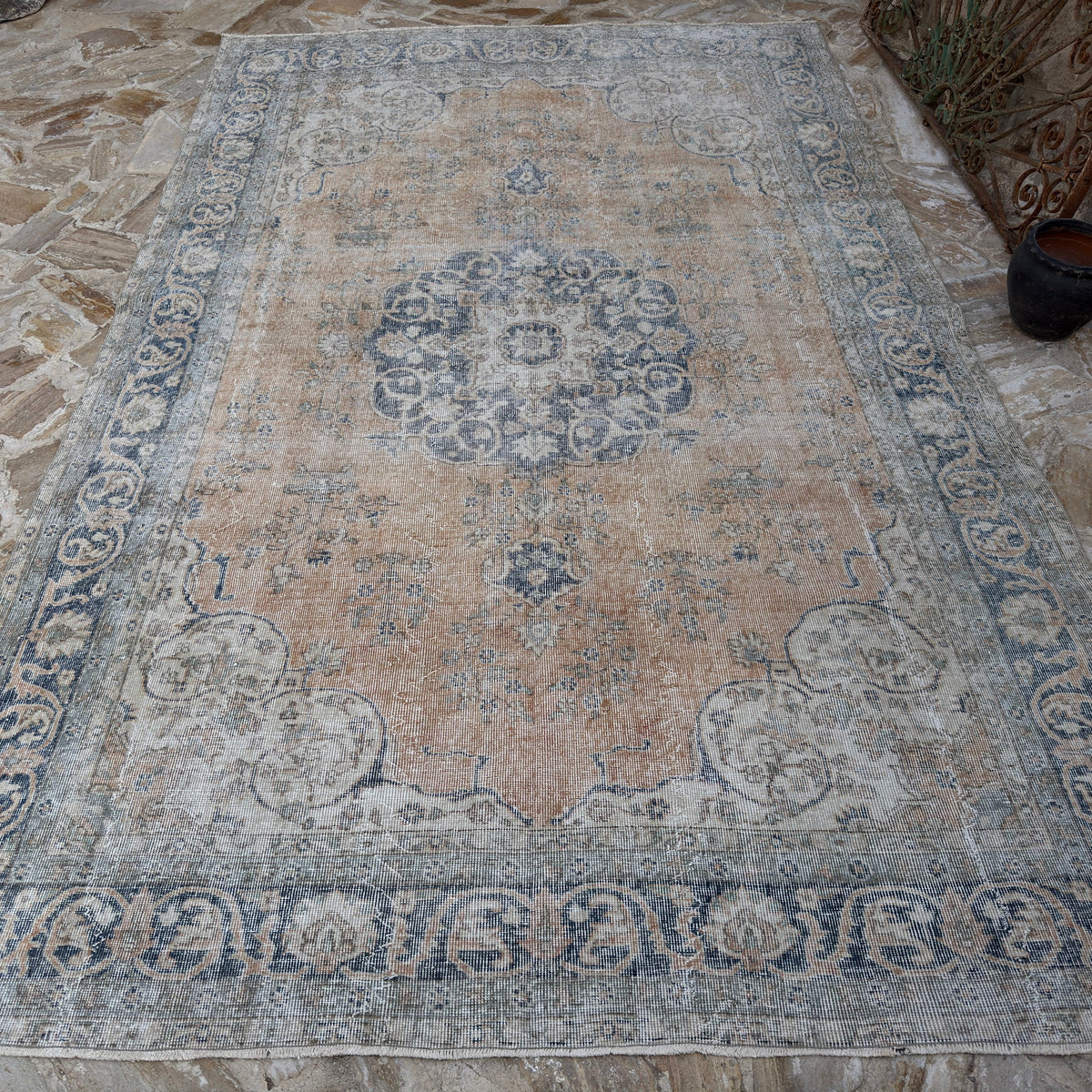 Close-up of the orange vintage Turkish wool rug showing medallion details, hand-knotted weave, wool and cotton and low pile.