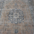 Orange 7' x 11' vintage Turkish wool rug in wool and cotton, shown on the floor.