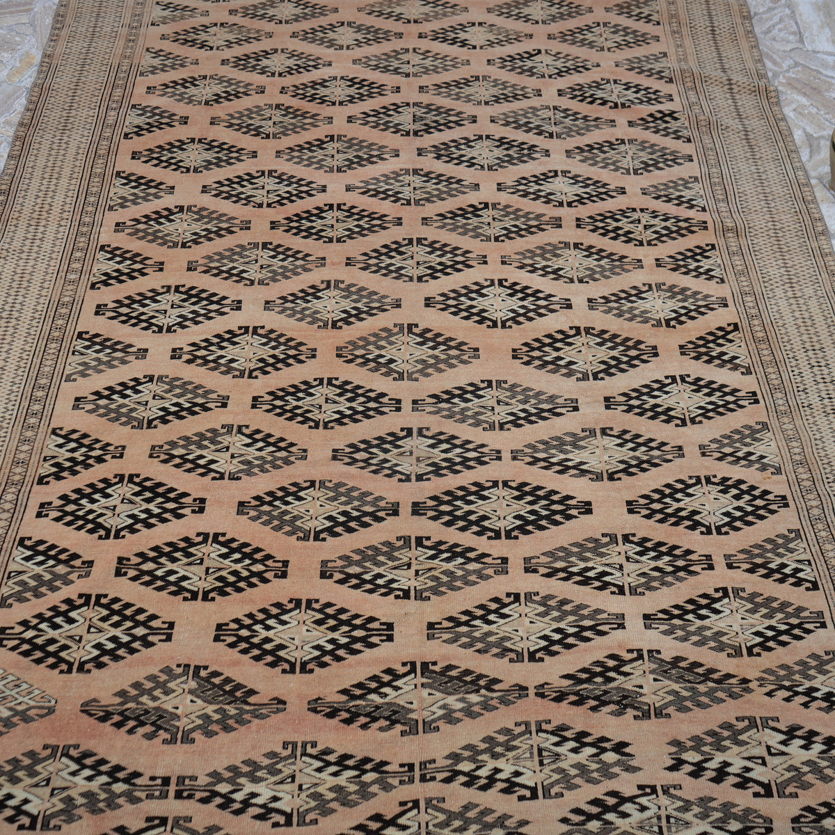 Close-up of the pale orange vintage Turkish wool rug showing neutral details, hand-knotted weave, wool and low pile.
