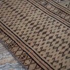 Pale Orange 7' x 11' vintage Turkish wool rug in wool, shown on the floor.