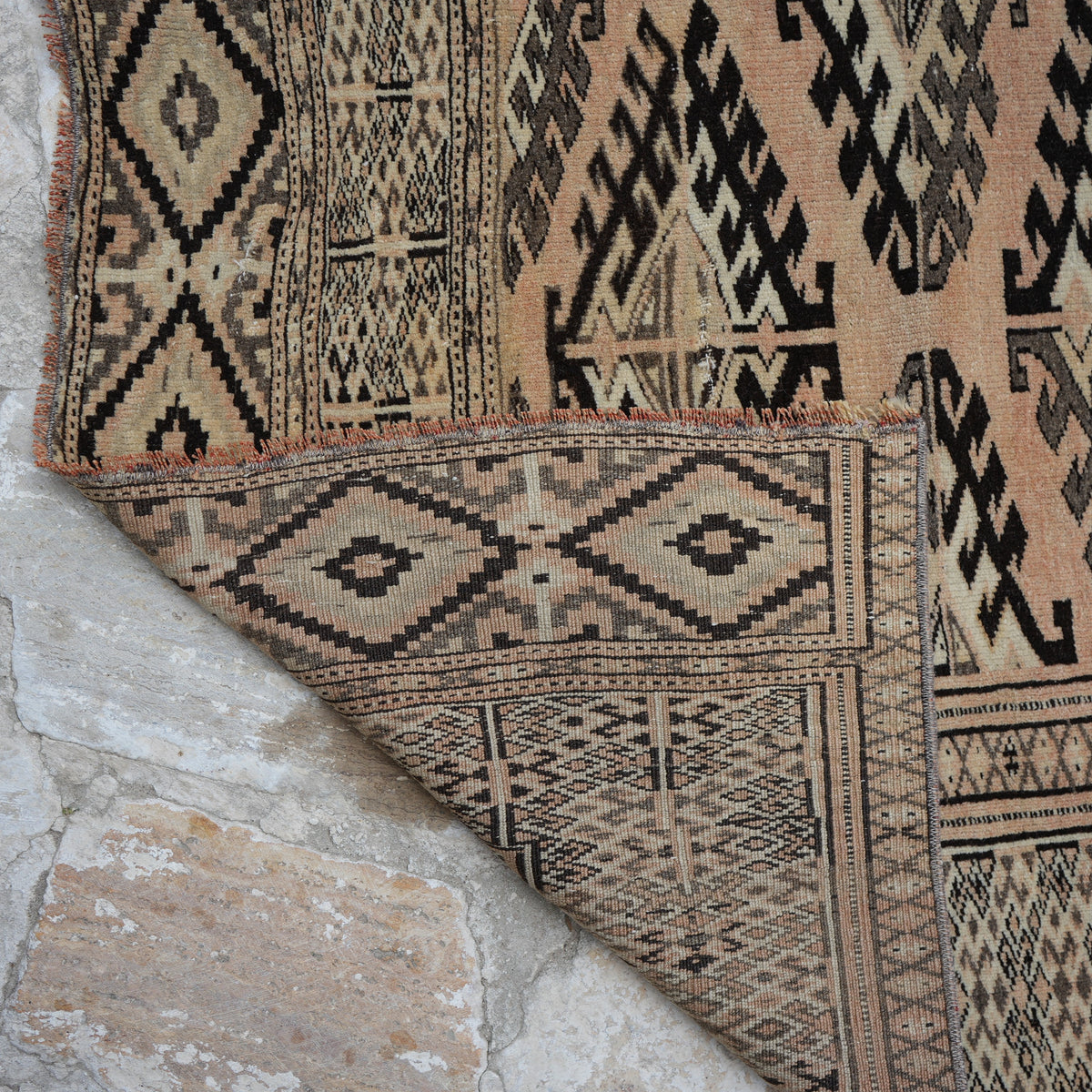 1970s pale orange vintage Turkish wool rug with neutral design, hand-knotted weave and low pile.