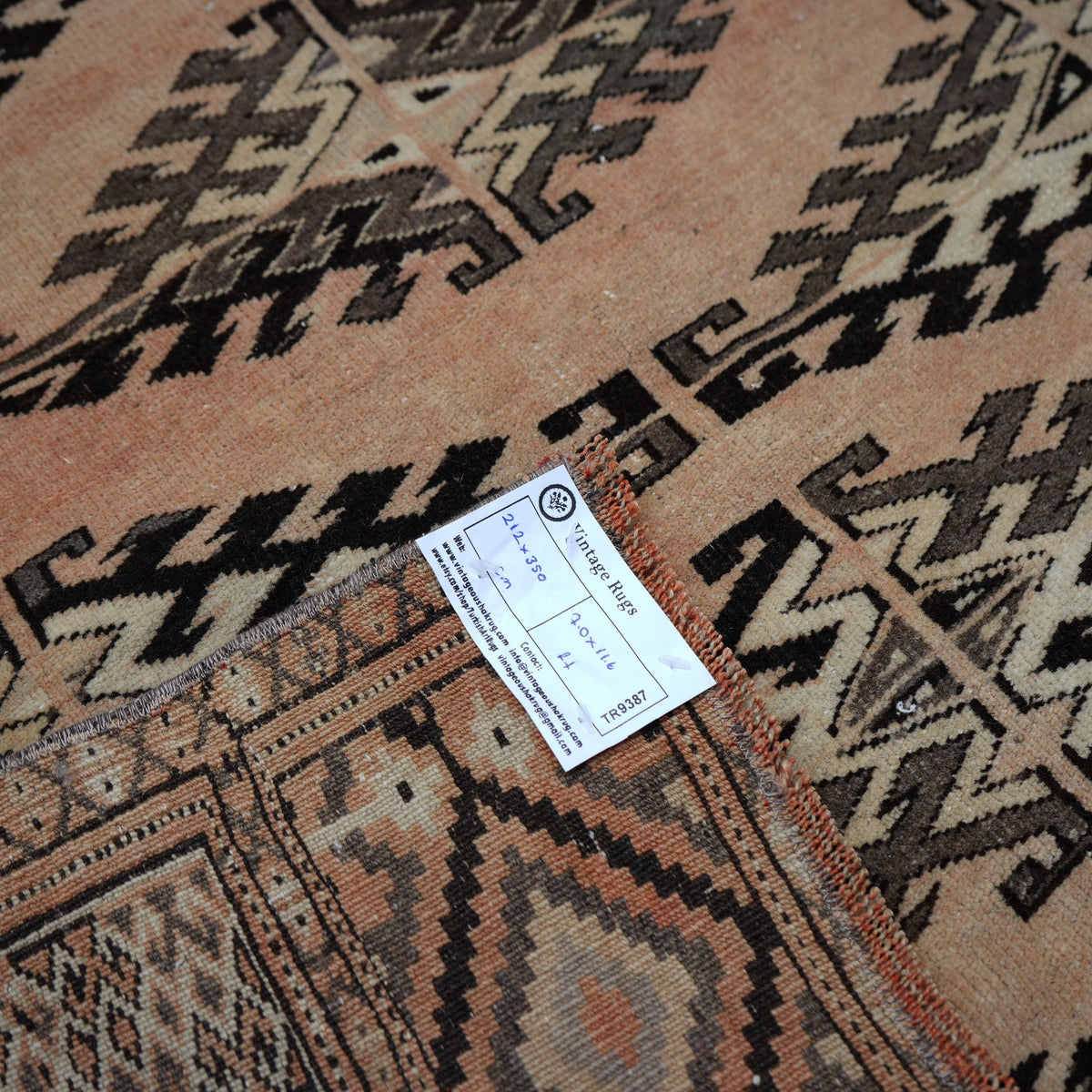 Pale Orange 7' x 11' vintage Turkish wool rug from the 1970s with neutral design.