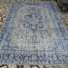 Pale Blue 7' x 10' Turkish wool distressed carpet in wool and cotton, shown on the floor.