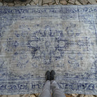 1970s pale blue Turkish wool distressed carpet with medallion design, hand-knotted weave and low pile.