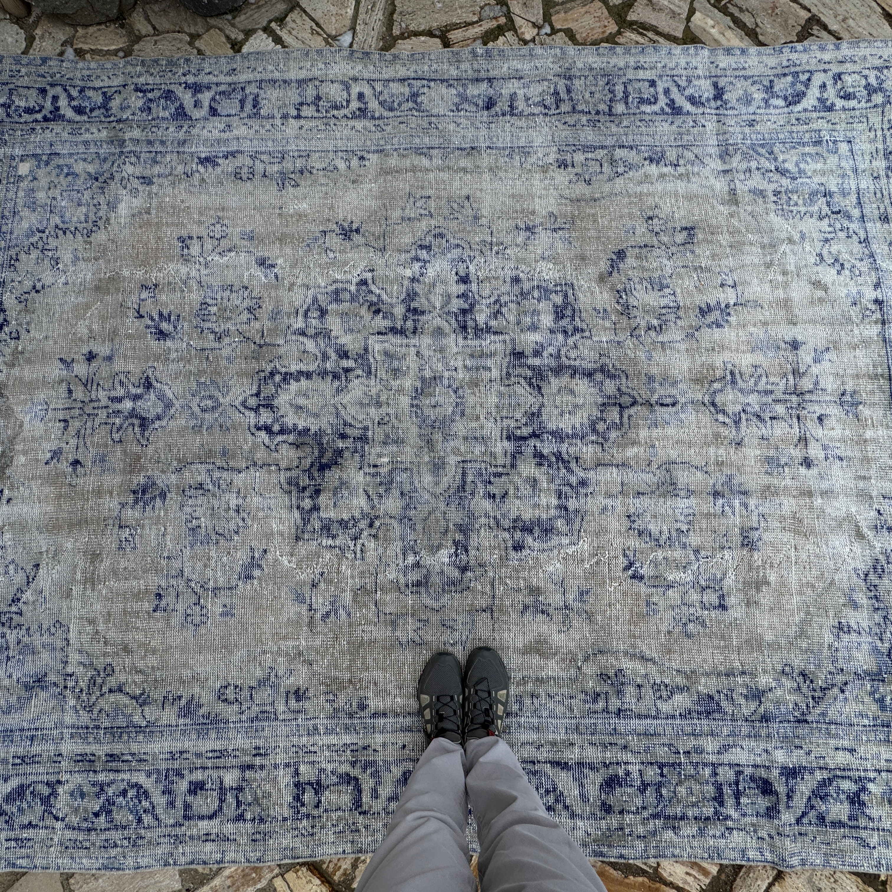 1970s pale blue Turkish wool distressed carpet with medallion design, hand-knotted weave and low pile.
