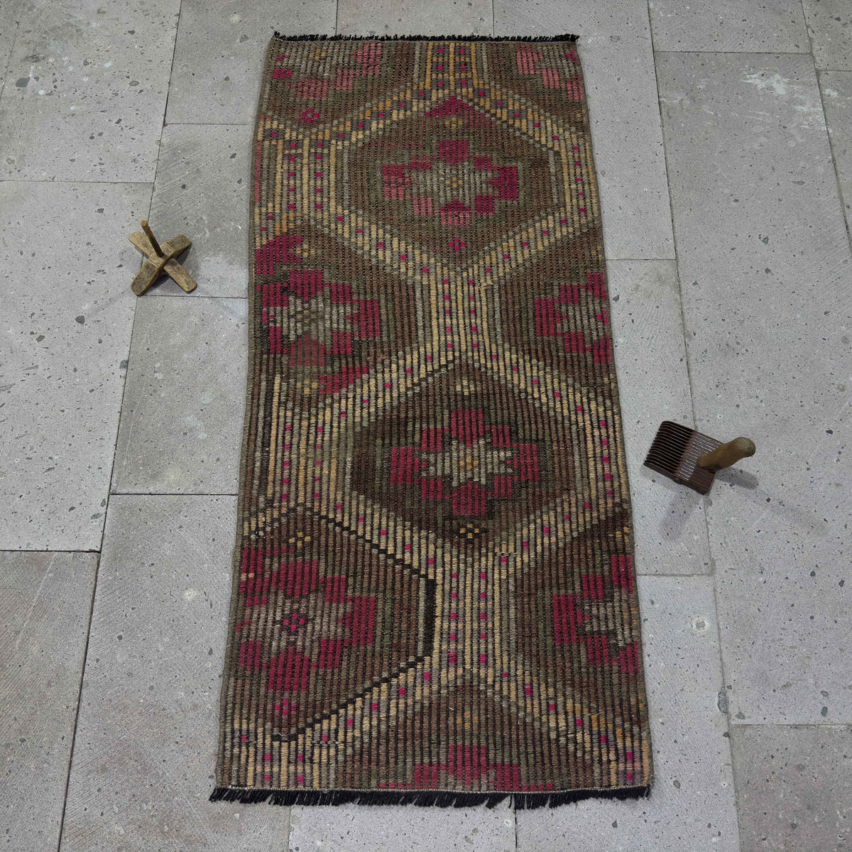 Brown 2' x 4' Turkish wool kilim rug in wool and cotton, shown on the floor.