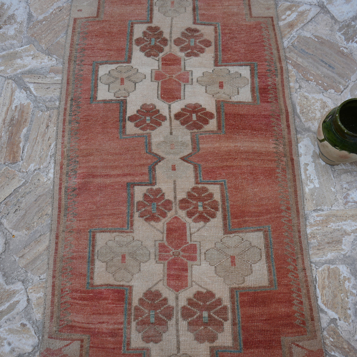 Close-up of the red Turkish wool runner rug showing traditional details, hand-knotted weave, wool and low pile.