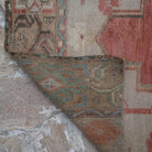 1970s red Turkish wool runner rug with traditional design, hand-knotted weave and low pile.