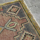 Close-up of the yellow Turkish wool traditonal rug showing traditional details, hand-knotted weave, wool and cotton and low pile.