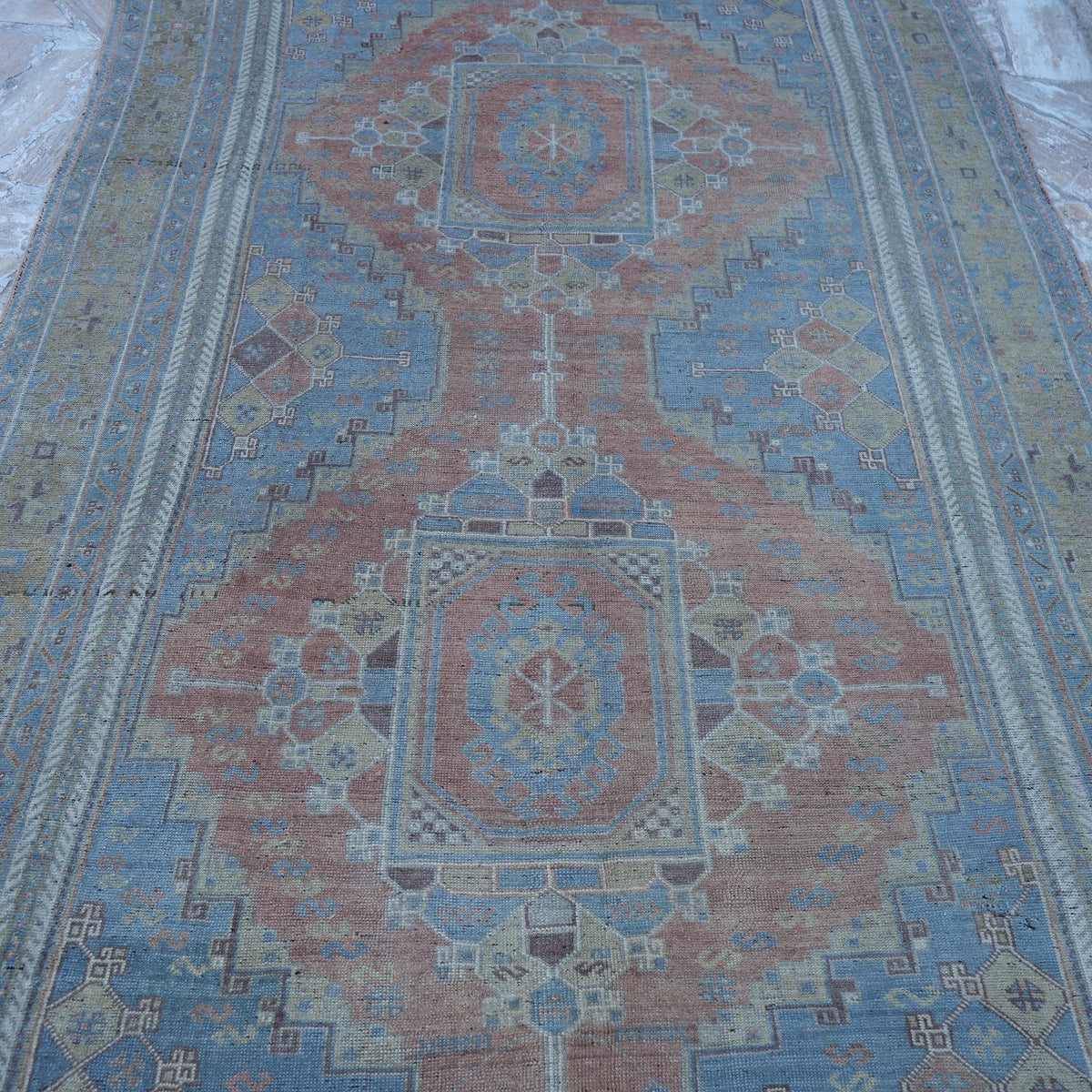 Close-up of the blue wool turkish rug showing traditional details, hand-knotted weave, wool and low pile.