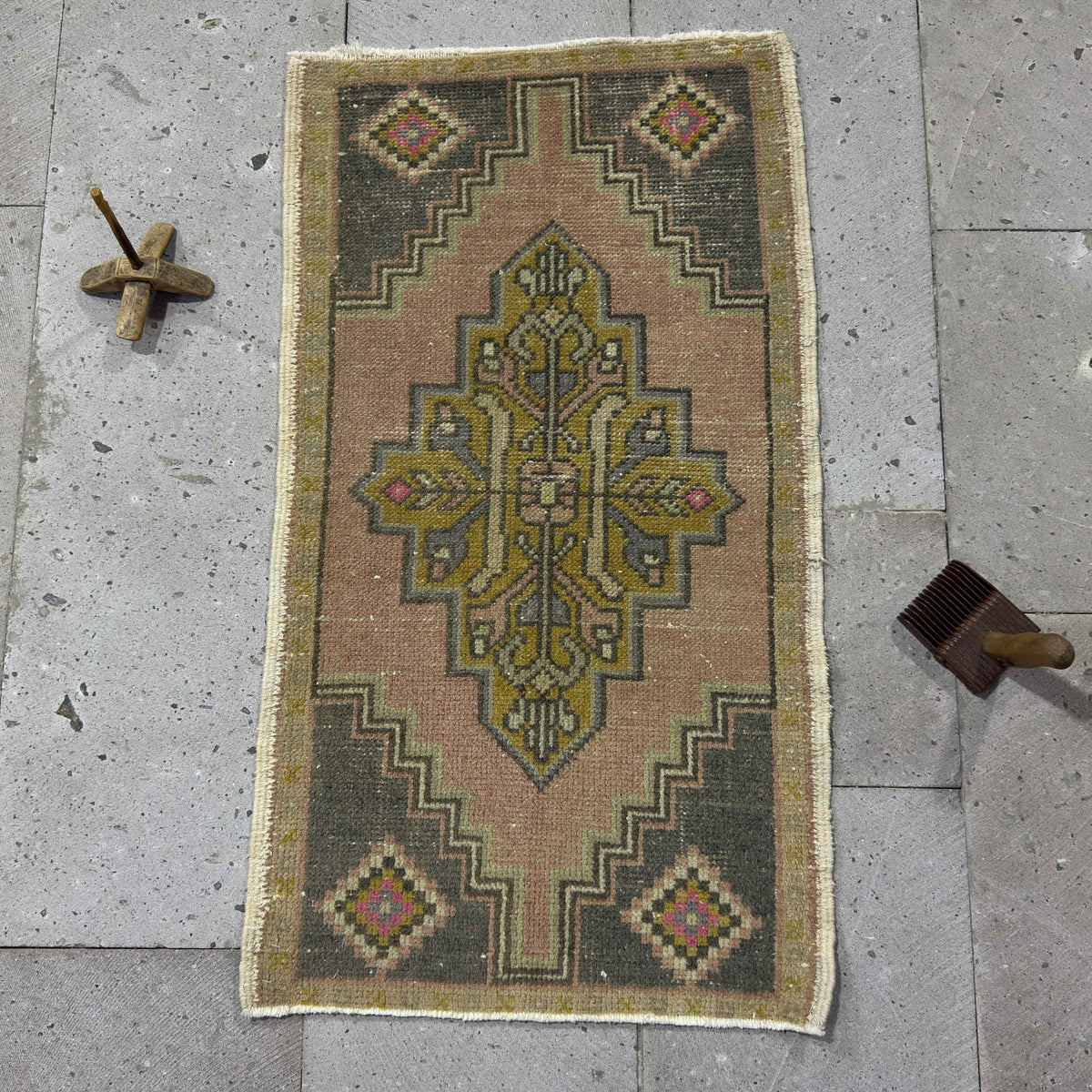 Pale Pink 2' x 3' Turkish wool vintage rug in wool and cotton, shown on the floor.