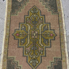 1970s pale pink Turkish wool vintage rug with traditional design, hand-knotted weave and low pile.