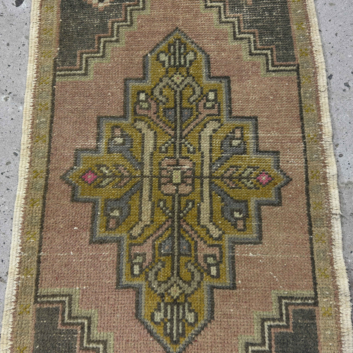 1970s pale pink Turkish wool vintage rug with traditional design, hand-knotted weave and low pile.
