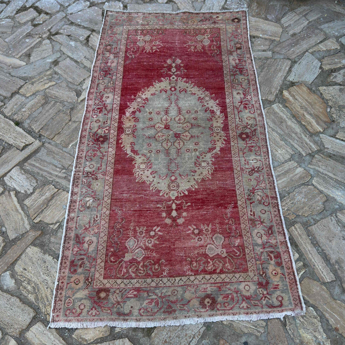 Red 3' x 7' Turkish wool vintage rug in wool and cotton, shown on the floor.
