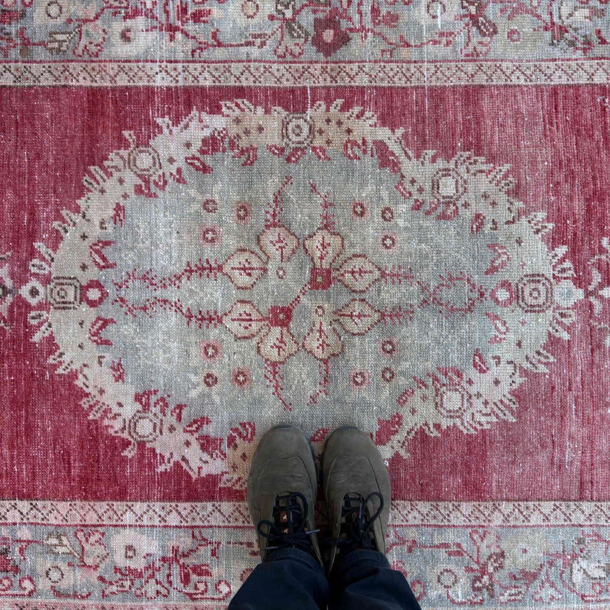 1970s red Turkish wool vintage rug with traditional design, hand-knotted weave and low pile.