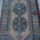 Close-up of the blue Turkish wool vintage rug showing geometric details, hand-knotted weave, wool and low pile.