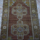 Close-up of the brown Turkish wool vintage rug showing traditional details, hand-knotted weave, wool and low pile.