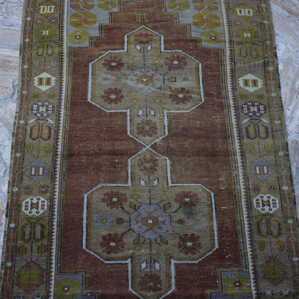 Close-up of the brown Turkish wool vintage rug showing traditional details, hand-knotted weave, wool and low pile.
