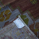 Brown 4' x 7' Turkish wool vintage rug from the 1970s with traditional design.