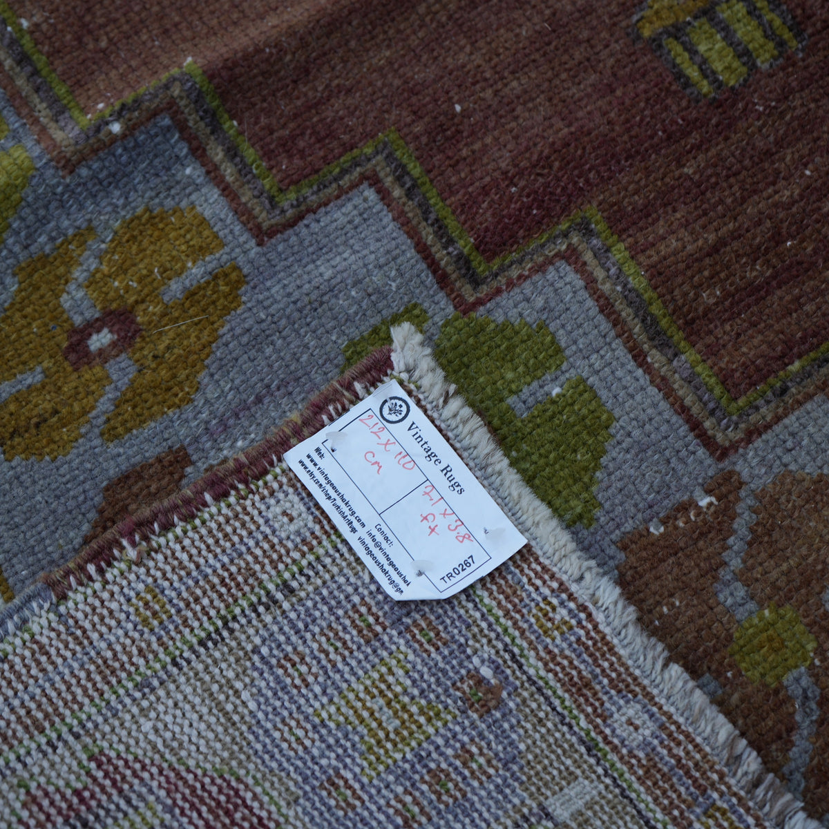 Brown 4' x 7' Turkish wool vintage rug from the 1970s with traditional design.