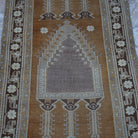 Close-up of the warm brown Turkish wool vintage rug showing neutral details, hand-knotted weave, wool and low pile.
