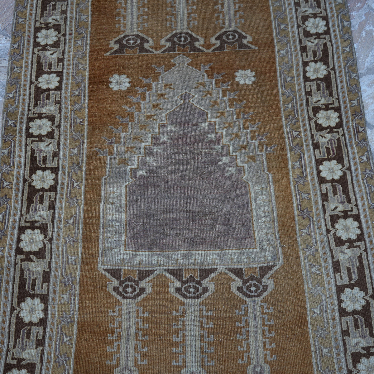 Close-up of the warm brown Turkish wool vintage rug showing neutral details, hand-knotted weave, wool and low pile.