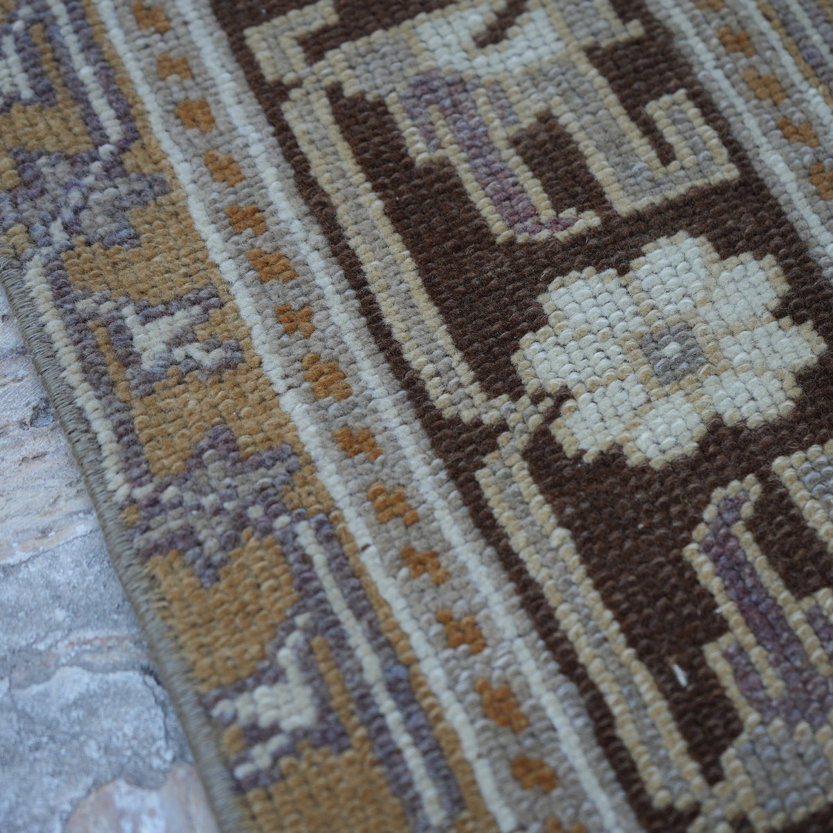 Warm Brown 4' x 7' Turkish wool vintage rug in wool, shown on the floor.