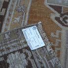 Warm Brown 4' x 7' Turkish wool vintage rug from the 1970s with neutral design.