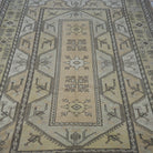 Close-up of the yellow Turkish wool vintage rug showing geometric details, hand-knotted weave, wool and low pile.