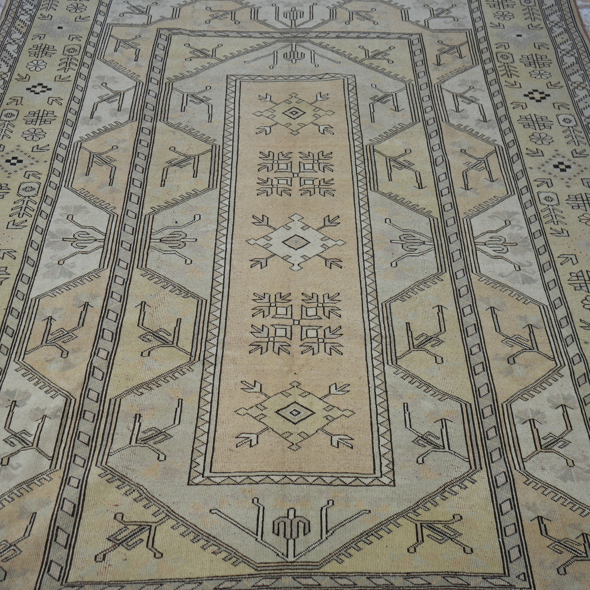Close-up of the yellow Turkish wool vintage rug showing geometric details, hand-knotted weave, wool and low pile.