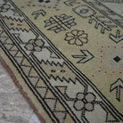 Yellow 8' x 11' Turkish wool vintage rug in wool, shown on the floor.